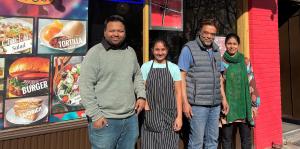 The four owners of Hungry Bites, a Downtown Albany NY eatery, stand in front of their business