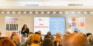 Georgette Steffens presenting to crowd of people at Annual Meeting