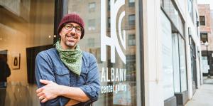 Man in front of Albany Center Gallery front window