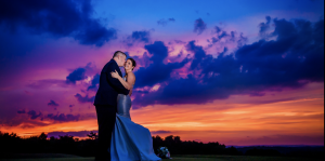 Bride and groom wedding photograph with sunset in background