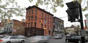 South Pearl street with blurry cars moving past buildings