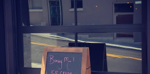 Exterior of Boozy Moo with sandwich board