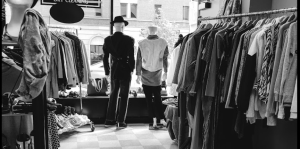 Black & white interior of European Tailoring & Alteration with garment racks and mannekins