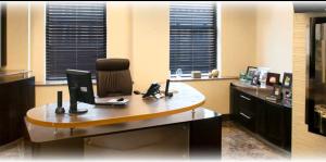 High end office decorated in gold and dark wood