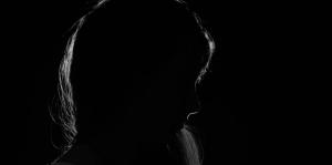 Woman in silhouette on dark background