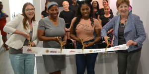 Business owners and Mayor Kathy Sheehan cutting ribbon