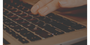 Picture of hand typing on keyboard