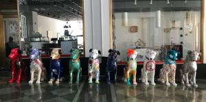 A row of painted nipper art sculptures sit facing the camera