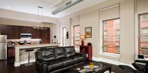 Living Room area with couch, chair, table with kitchen view