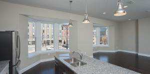 view from kitchen with island and sink, and windows of outside view  