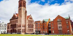 Albany City Hall building against a cloudy blue sky 