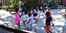 Group of kids walk down sidewalk