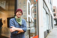 Man in front of Albany Center Gallery front window