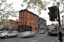 South Pearl street with blurry cars moving past buildings