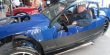 Man with derby hat sitting in classic car