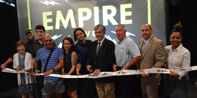 Group stands in line at ribbon cutting for Empire Live