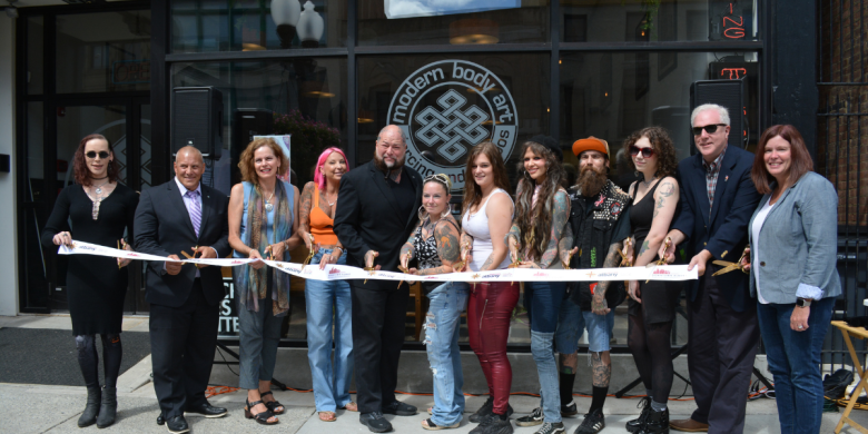 People stand in line at ribbon cutting at Modern Body Art