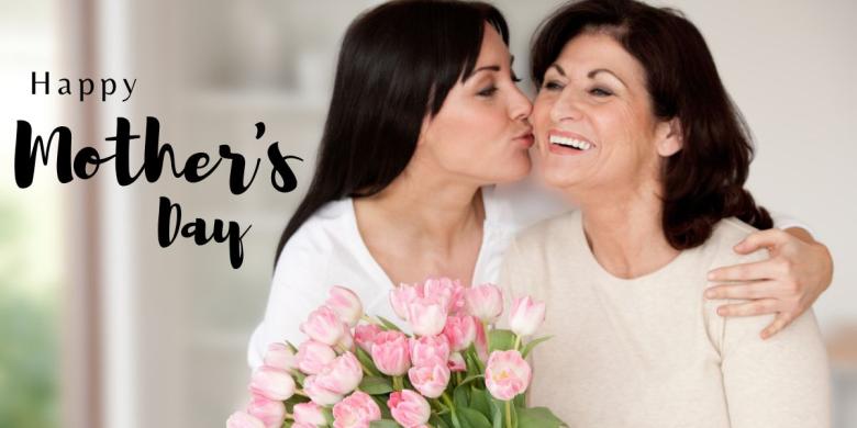 Two women hug while holding tulips. At left, text reads Happy Mother's Day.