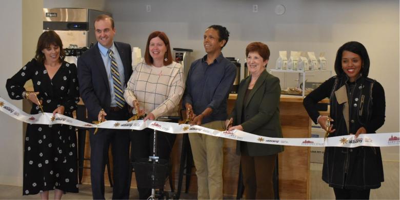 People stand in row at ribbon cutting ceremony