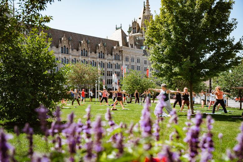 Participants doing yoga at SUNY Plaza in downtown Albany