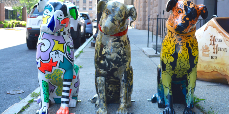 Three decorated canine statues on Lodge Street
