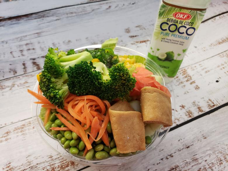 Bowl full of vegetables like broccoli, carrots, and green peas